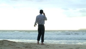 Man on the Beach for Airport Management with Cell/Mobile Phone